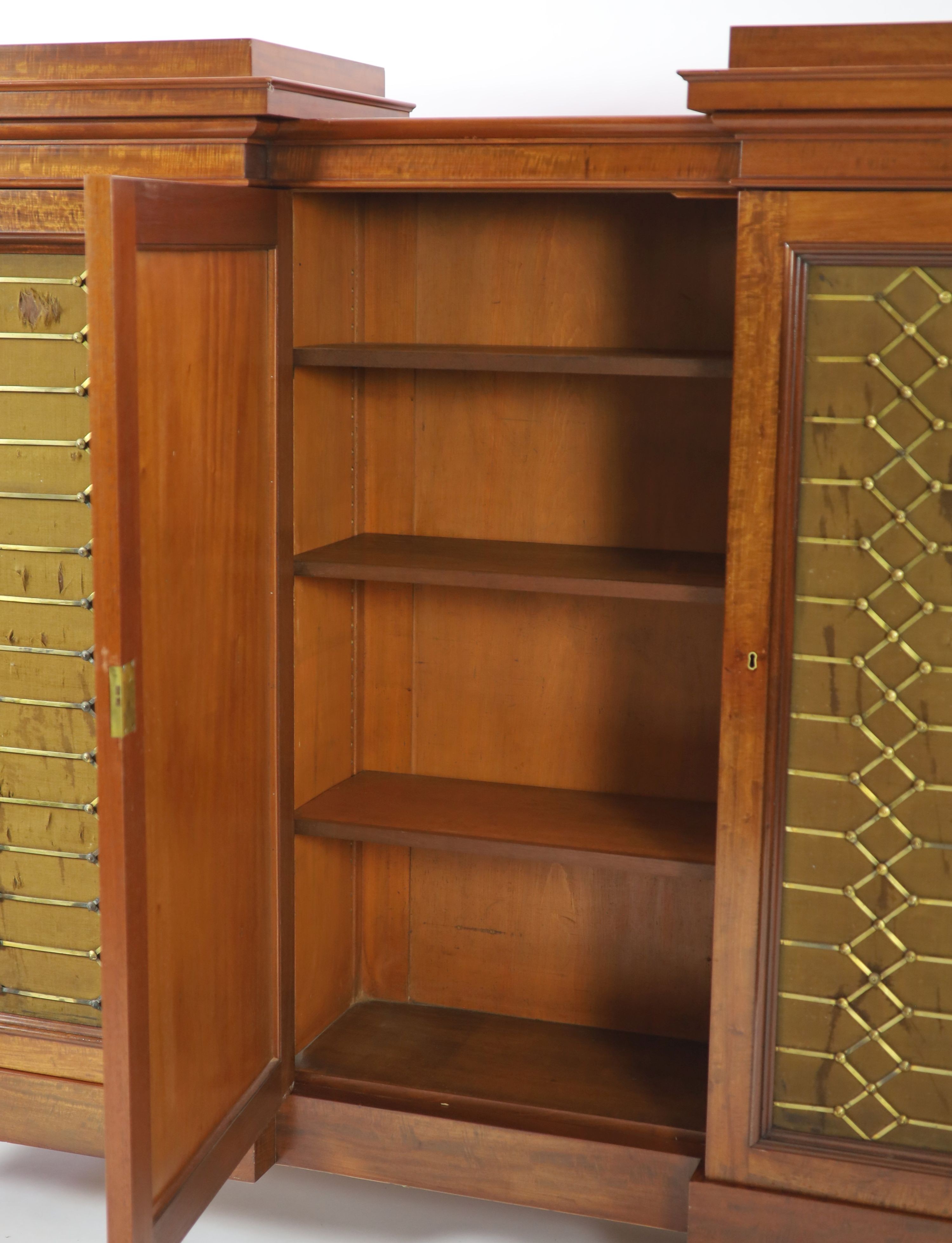 An early Victorian flame mahogany triple breakfront library cabinet, W.330cm D.51cm H.152cm